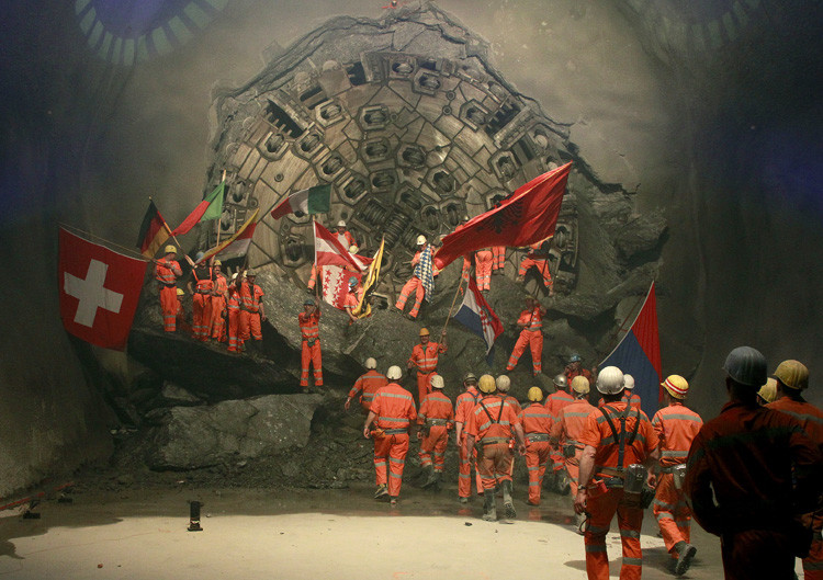 Mineros sujetan las banderas de distintos países europeos durante la última fase deconstrucción del túnel en la sección Sedrun-Faido, el 23 de marzo de 2011. 