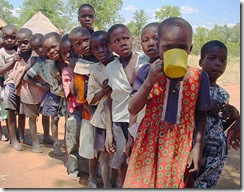 Children line up for a meal at a CARE supplementary feeding program in Masvingo province, Zimbabwe. 