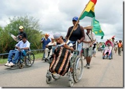 Disabled people demanding rights and privileges march towards La Paz along the road that connects Trinidad and Santa Cruz, near Pailon, on December 9, 2011. Some 50 Bolivians with disabilities have been marching for nearly a month now to demand the parliament for a law that grants them jobs, training, early retirement, discounts in the public transportation system and an annual bond of 430 US dollars among other things.  AFP PHOTO/STR