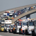 Recovery vehicles line up to collect over 100 vehicles involved in multiple collisions in dense fog during the morning rush hour on the Sheppey Bridge in Kent, east of London