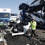 A police officer reacts as he stands amongst the wreckage of some of the 100 vehicles involved in multiple collisions, which took place in dense fog during the morning rush hour, on the Sheppey Bridge in Kent, east of London