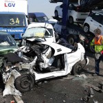 A rescue worker stands amongst the wreckage of some of the 100 vehicles involved in multiple collisions, which took place in dense fog during the morning rush hour, on the Sheppey Bridge in Kent, east of London