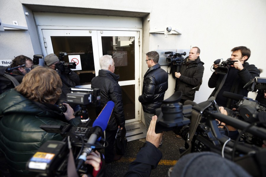 Members of the media surround Rolf and Ralf Schumacher, father and brother of former Formula One world champion Michael Schumacher respectively, as they arrive at CHU hospital emergency unit in Grenoble