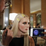 A model gets her makeup done backstage before the Italian designer Donatella Versace Haute Couture Spring/Summer 2014 fashion show for Atelier Versace in Paris