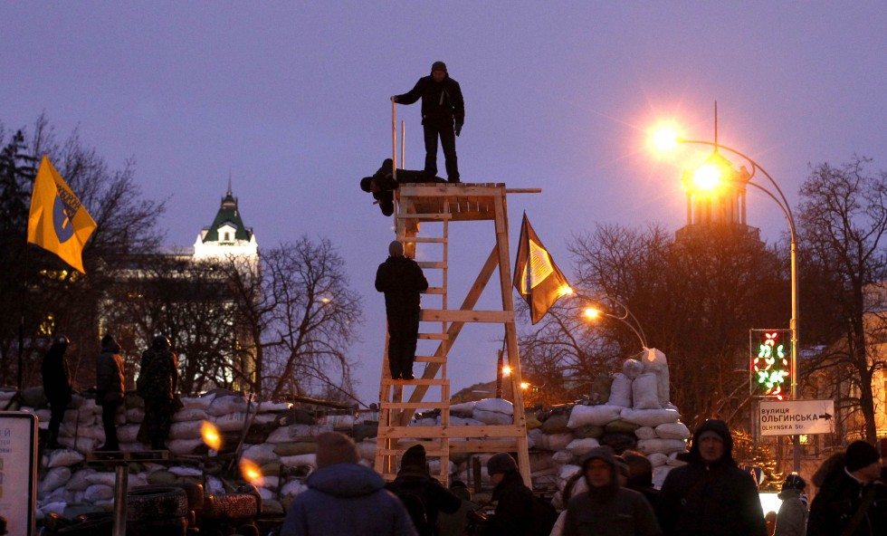 Anti-government protesters build a lookout tower at their barricade in central Kiev