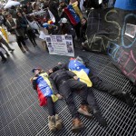 People imitate dead bodies as they lie on the ground in protest at what they say is an oppressive regime in Venezuela, in Times Square in New York