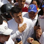 Venezuela's opposition leader Leopoldo Lopez, wanted on charges of fomenting deadly violence, walks through a demonstration of his supporters in Caracas