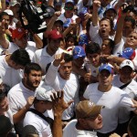 Venezuela's opposition leader Leopoldo Lopez, wanted on charges of fomenting deadly violence, walks through a demonstration of his supporters in Caracas