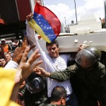 Venezuelan opposition leader Leopoldo Lopez gets into a National Guard armored vehicle in Caracas