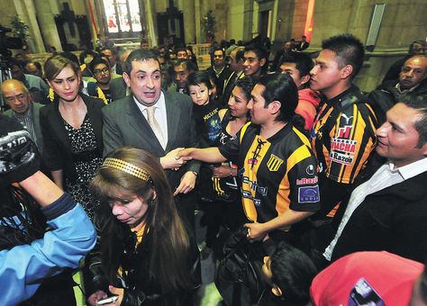 Apoyo. El presidente Reintsch (centro) junto a su esposa, Romy Paniagua, recibe el aliento de los hinchas en la Catedral.