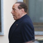 Former Italian PM Berlusconi looks on as he arrives to the Sacred Family Foundation in Cesano Boscone