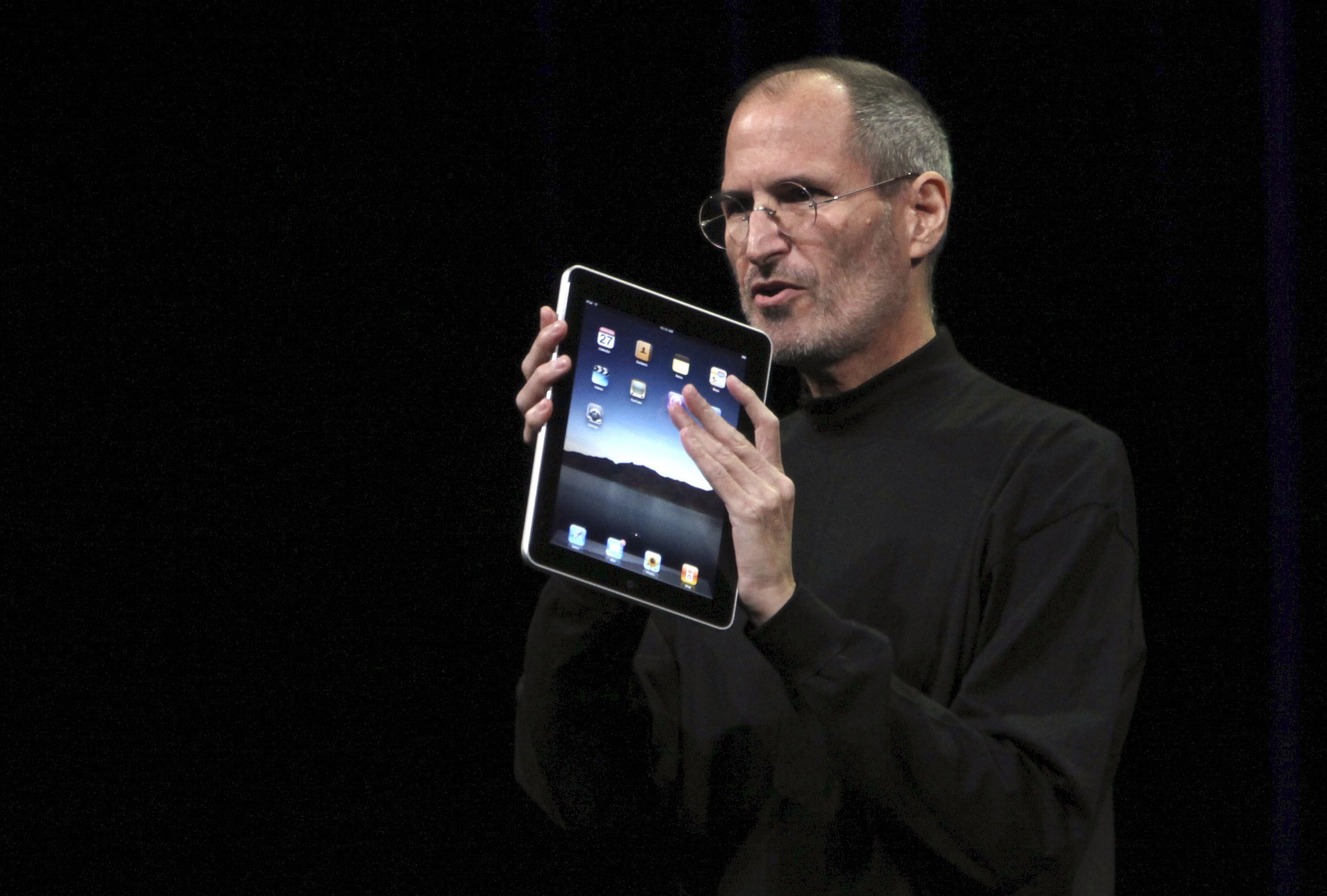 Apple CEO Steve Jobs holds the new " iPad" during the launch of Apple's new tablet computing device in San Francisco