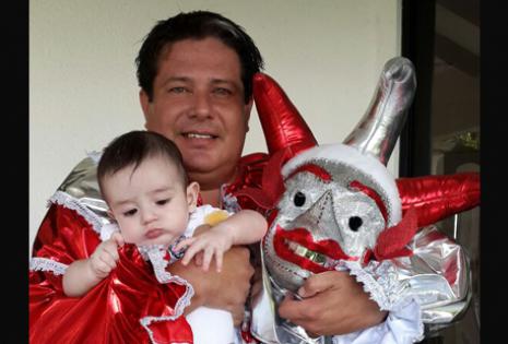 Vestido de pepino y con su pequeño en brazos