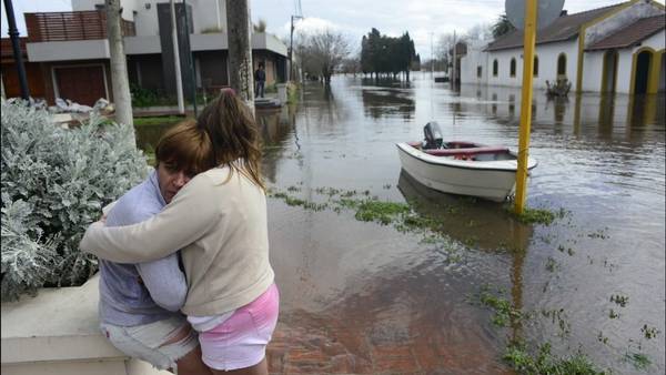 Dolor. Mónica Alonso y su hija Sara, abrazadas, esperaban ayer que el agua bajara en Salto. La ciudad sufre la peor inundación de su historia, por la crecida del Arrecifes. DAVID FERNANDEZ