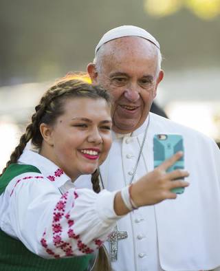 El papa Francisco posa para una fotografía con una jovencita dureante su visita a la ciudad de Washington.