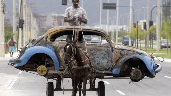 Carro. La carrocería de un viejo Escarabajo, llevada por un caballo, en Río de Janeiro. /REUTERS