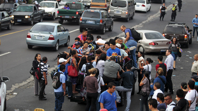 La gente trata de abordar una camioneta en Mejicanos, El Salvador.