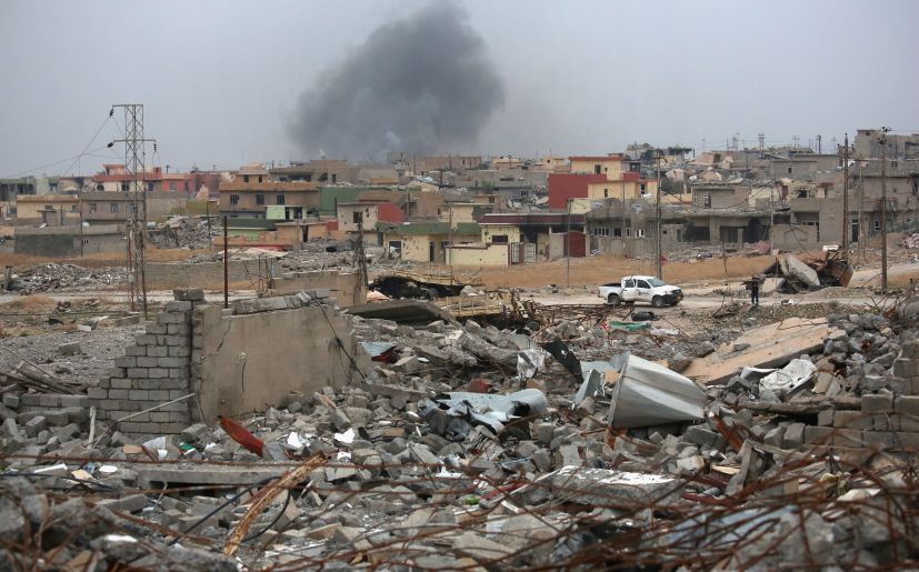 SINJAR, IRAQ - NOVEMBER 16:  Smoke rises in the distance, on a day when ISIL fighters fired multiple Katyusha rockets at Kurdish Peshmerga forces occupying the ruins of the town on November 16, 2015 in Sinjar, Iraq. The Kurds, with the aid of months of U.S.-led coalition airstrikes, liberated the town from ISIL extremists, known in Arabic as Daesh, in recent days. Although the battle was deemed a major victory, much of the city lay in complete ruins and is still vulnerable to attack.  (Photo by John Moore/Getty Images)