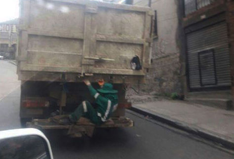 Un trabajador viaja en la parte baja de un camión arriesgando la vida