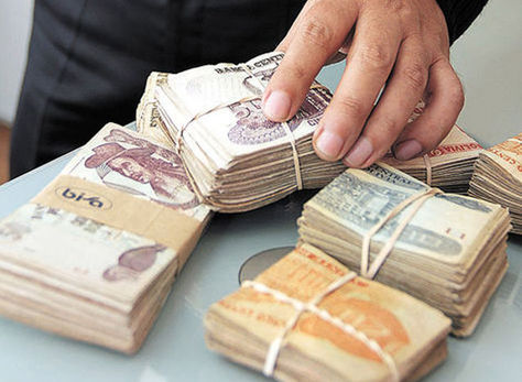 Un ciudadano retira una alta suma de dinero de una entidad financiera. Foto: La Razón - archivo