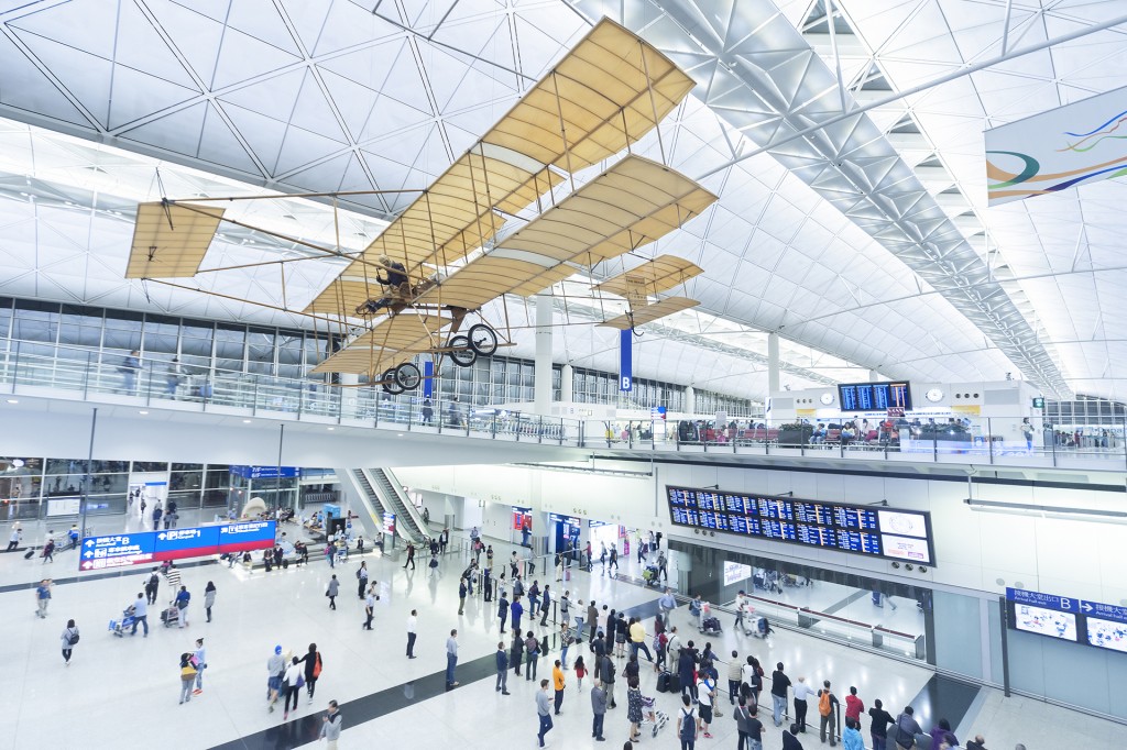 Hong Kong, China – April 15, 2015 : Passengers in the airport main lobby in Hong Kong, China. The Hong Kong airport handles more than 70 million passengers per year.