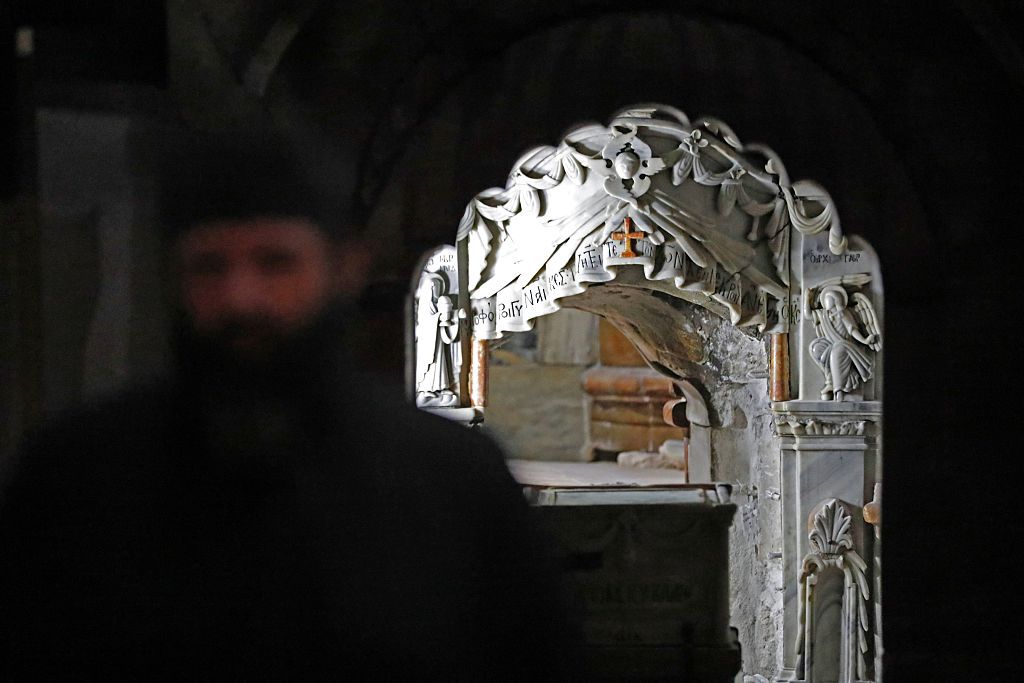 A Greek Orthodox priest stands in front of the Tomb of Jesus at the Church of the Holy Sepulchre in Jerusalem's Old City on October 28, 2016. The tomb where Jesus is said to have been buried before his resurrection, is to undergo major restoration. The restoration entrusted to a Greek team, is expected to be completed in early 2017 and the site will remain open to visitors in the meantime. / AFP / THOMAS COEX (Photo credit should read THOMAS COEX/AFP/Getty Images)