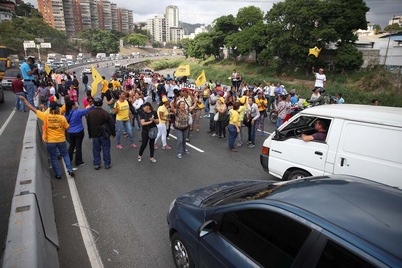 Opposition supporters shout slogans as they block a highway during a protest against Venezuelan President Nicolas Maduro