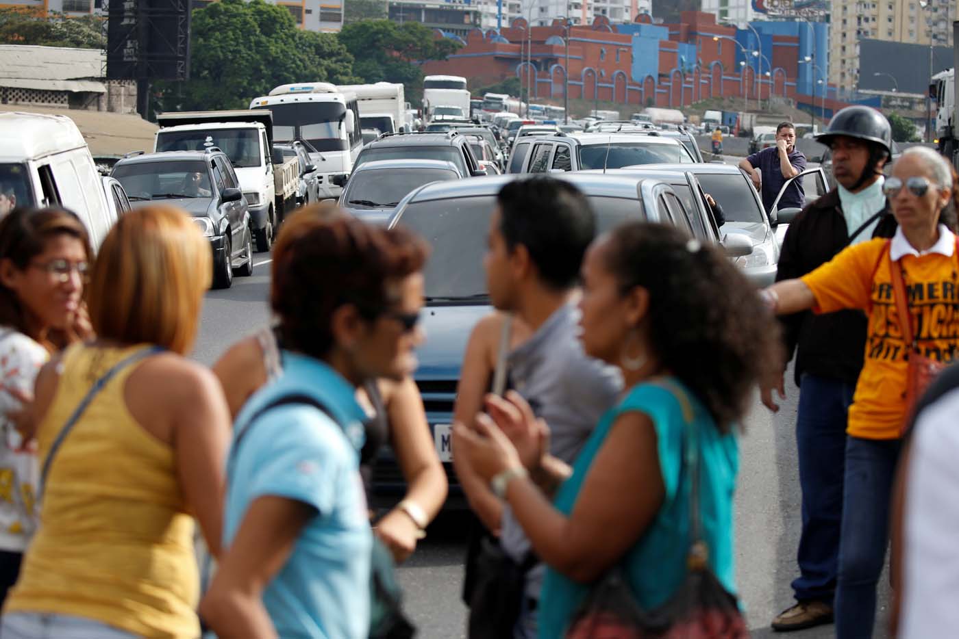 Opposition supporters shout slogans as they block a highway during a protest against Venezuelan President Nicolas Maduro