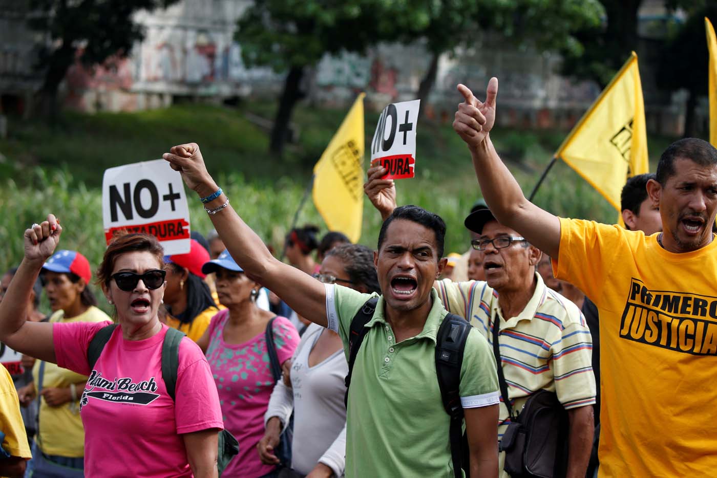 Opposition supporters shout slogans as they block a highway during a protest against Venezuelan President Nicolas Maduro