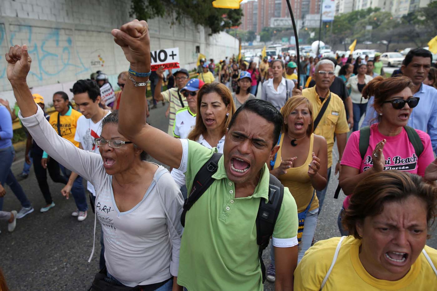 Opposition supporters shout slogans as they block a highway during a protest against Venezuelan President Nicolas Maduro
