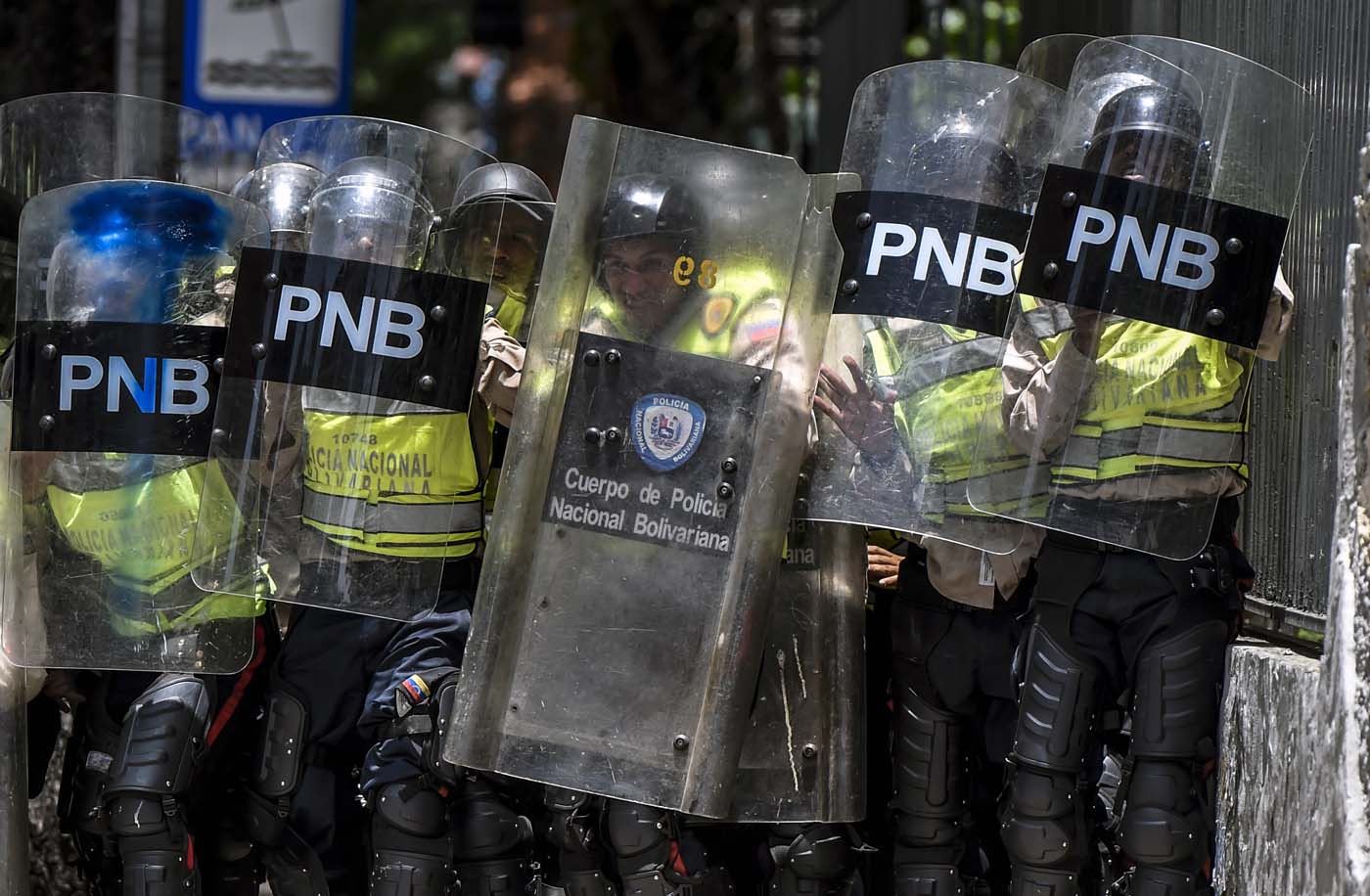 Bolivarian police agents hold their shields and prepare for confrontation during a protest against Nicolas Maduro