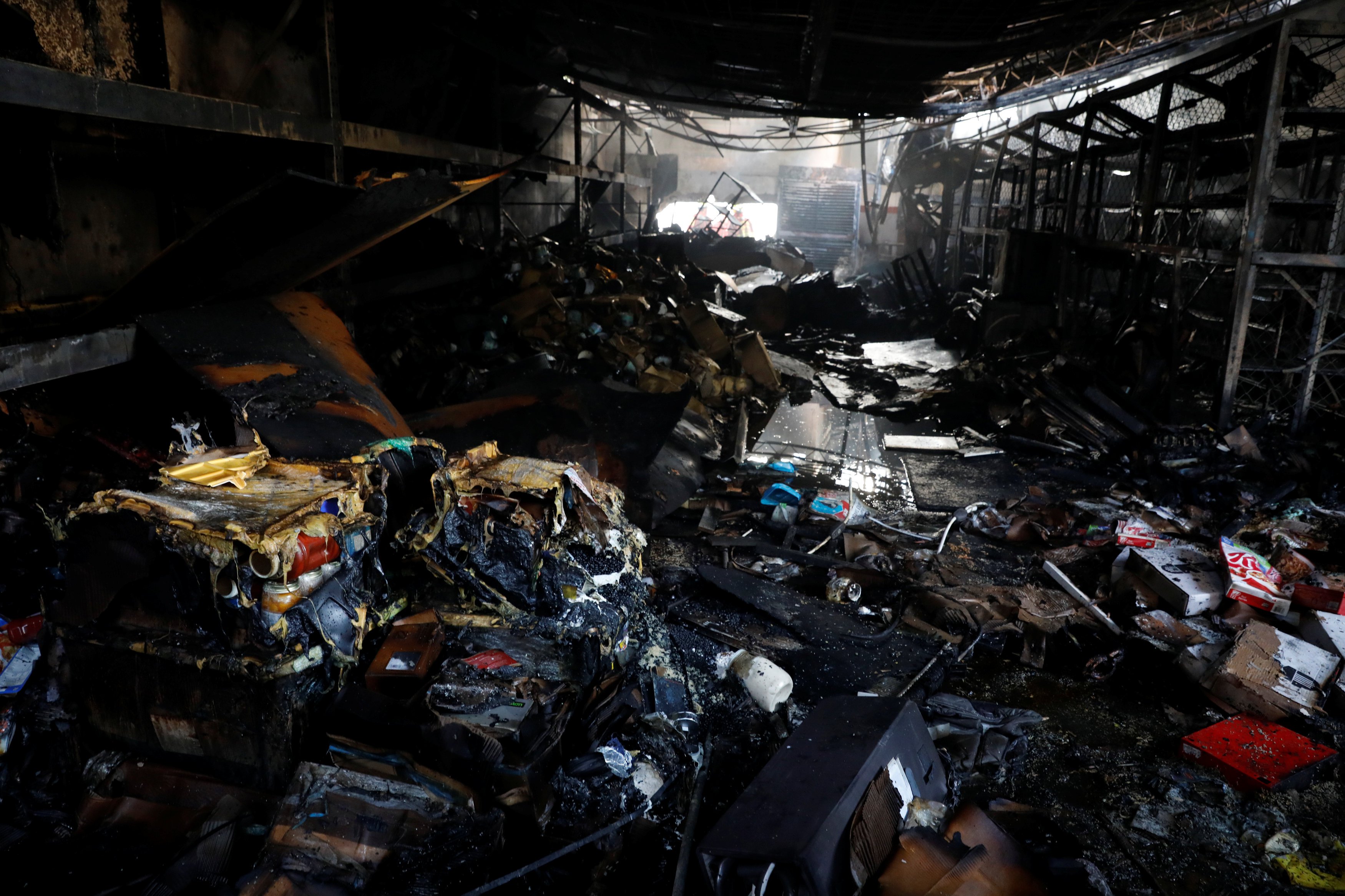 REFILE -CLARIFYING CAPTION  Burned debris are seen in a warehouse in the building where the offices of Venezuelan opposition leader and Governor of Miranda state Henrique Capriles are located, in Caracas, Venezuela, April 8, 2017. REUTERS/Carlos Garcia Rawlins