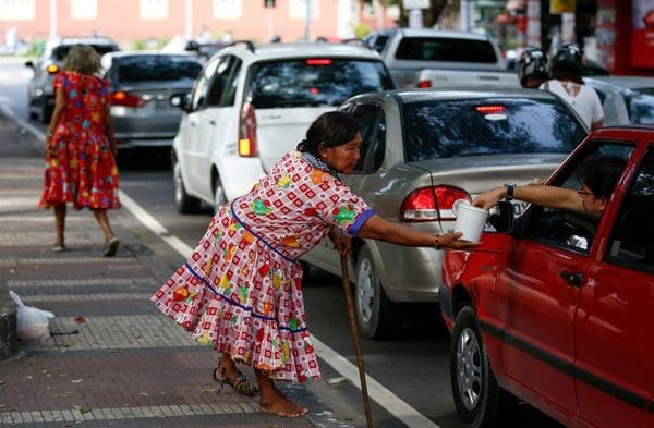 Una indígena venezolana pide monedas en la calles de Manaos (Reuters)