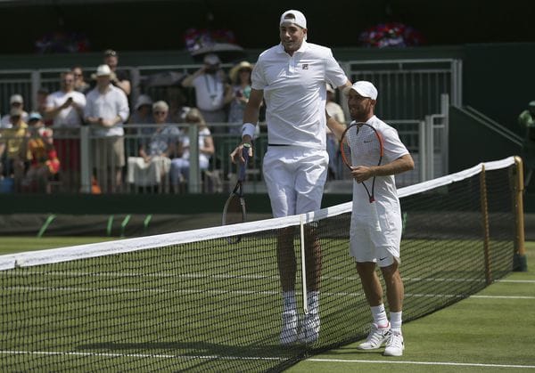 La diferencia de altura entre John Isner y Dudi Sela no pasó inadvertida (AP Photo/Tim Ireland)