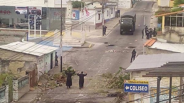 Los dos sacerdotes intentan mediar con las fuerzas de seguridad en las calles de Tovar (@Ciudad360Ve)