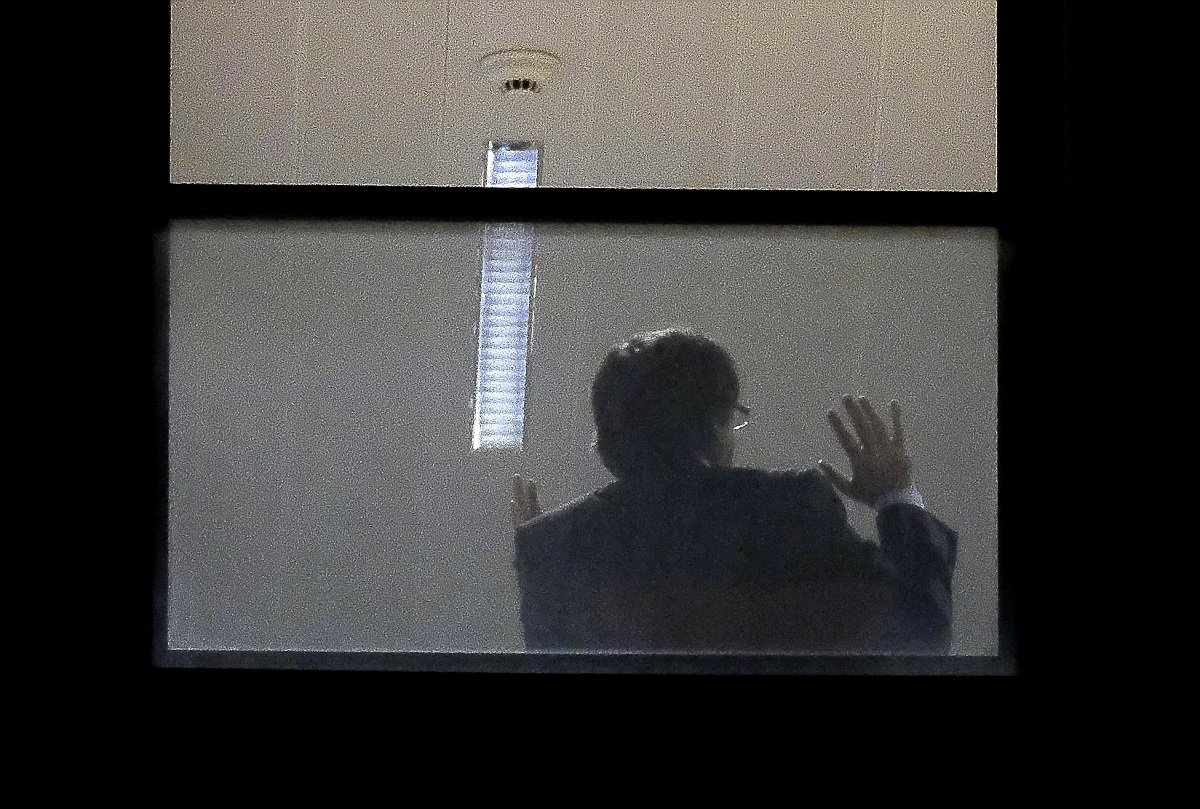A man believed to be Carles Puigdemont gestures inside the public prosecutor