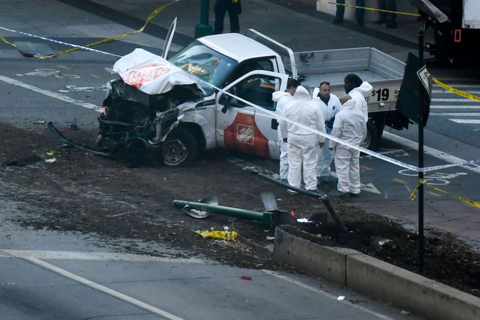 TOPSHOT - Investigators inspect a truck following a shooting incident in New York on October 31, 2017. Several people were killed and numerous others injured in New York on Tuesday after a vehicle plowed into a pedestrian and bike path in Lower Manhattan, police said. "The vehicle struck multiple people on the path," police tweeted. "The vehicle continued south striking another vehicle. The suspect exited the vehicle displaying imitation firearms & was shot by NYPD." / AFP PHOTO / DON EMMERT (Photo credit should read DON EMMERT/AFP/Getty Images)