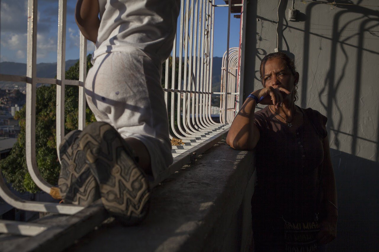 Elibeth Pulido, mother of the late Jose Daniel Bruzual, looks out the window of their home in Caracas.
