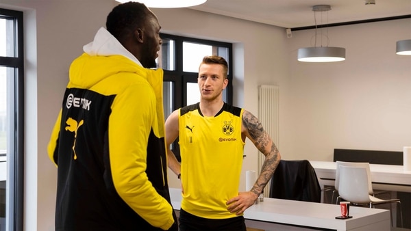Usain Bolt junto a Marco Reus, una de las máximas figuras del Borussia Dortmund