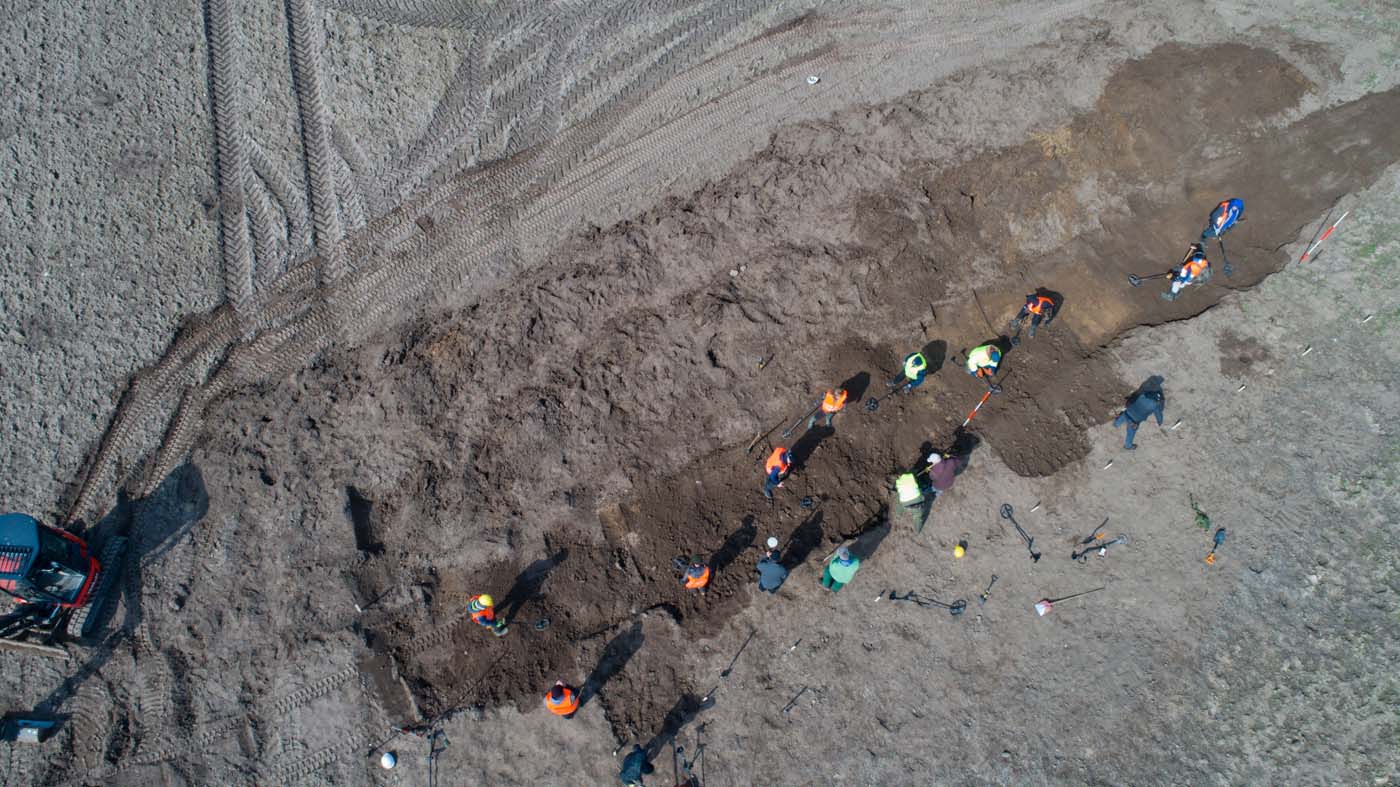 This aerial picture taken with a drone on April 13, 2018 shows archaeologists looking for a treasure in Schaprode, northern Germany. A 13-year-old boy and a hobby archaeologist have unearthed a "significant" trove in Germany which may have belonged to the legendary Danish king Harald Bluetooth who brought Christianity to Denmark. A dig covering 400 square metres (4,300 square feet) that finally started over the weekend by the regional archaeology service has since uncovered a trove believed linked to the Danish king who reigned from around 958 to 986. Braided necklaces, pearls, brooches, a Thor
