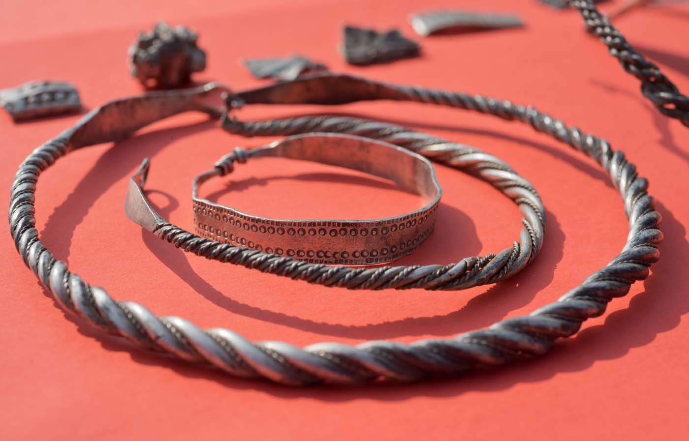 Parts of the silver treasure are pictured on a table in Schaprode, northern Germany on April 13, 2018. A 13-year-old boy and a hobby archaeologist have unearthed a "significant" trove in Germany which may have belonged to the legendary Danish king Harald Bluetooth who brought Christianity to Denmark. A dig covering 400 square metres (4,300 square feet) that finally started over the weekend by the regional archaeology service has since uncovered a trove believed linked to the Danish king who reigned from around 958 to 986. Braided necklaces, pearls, brooches, a Thor