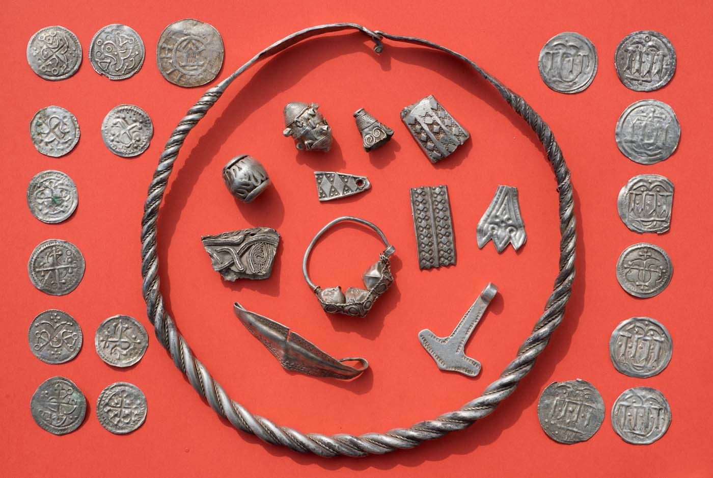 Parts of the silver treasure are pictured on a table in Schaprode, northern Germany on April 13, 2018. A 13-year-old boy and a hobby archaeologist have unearthed a "significant" trove in Germany which may have belonged to the legendary Danish king Harald Bluetooth who brought Christianity to Denmark. A dig covering 400 square metres (4,300 square feet) that finally started over the weekend by the regional archaeology service has since uncovered a trove believed linked to the Danish king who reigned from around 958 to 986. Braided necklaces, pearls, brooches, a Thor