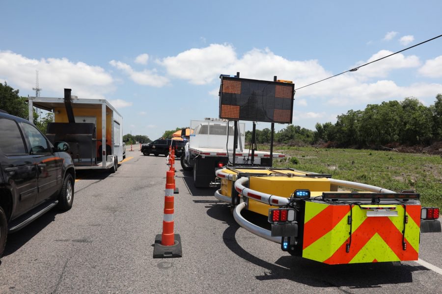 Police keep a roadblock on a main road to Santa Fe High School where police found explosives after an early morning shool shooting that left several people dead in Santa Fe, Texas, U.S., May 18, 2018.  REUTERS/Trish Badger