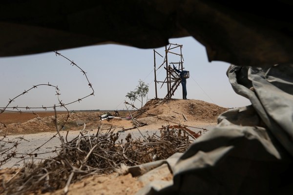 Un palestino revisa los daños sobre una torre de observación del grupo Yihad Islámica, en el sur de Gaza (Reuters)