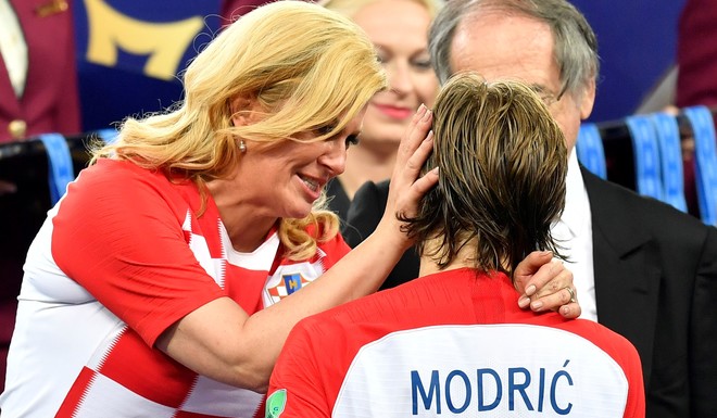 Croatian President Kolinda Grabar-Kitarovic hugs Croatias Luka Modric after France won the final match between France and Croatia at the 2018 soccer World Cup in the Luzhniki Stadium in Moscow, Russia, Sunday, July 15, 2018. (AP Photo/Martin Meissner)