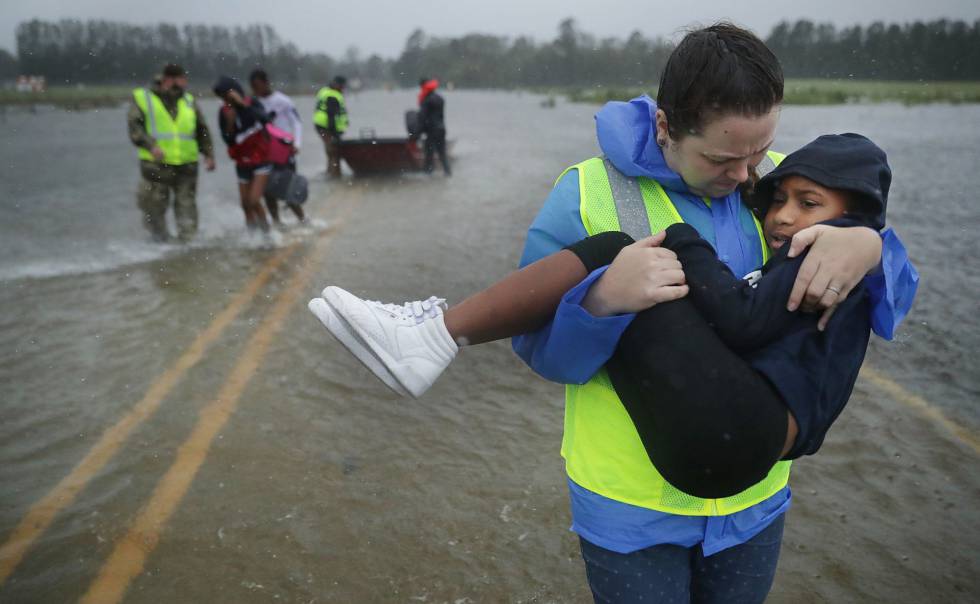 Voluntarios rescatan tres niños de su casa inundada en James City, EE UU.