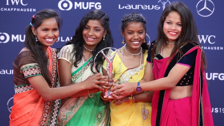 Un equipo femenino de fútbol caritativo de Yuwa (India) posan con su Premio Laureus (AFP)