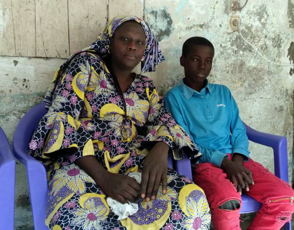 Manieme Ndoye, junto a uno de sus hijos, afectado de la enfermedad de las células falciformes.