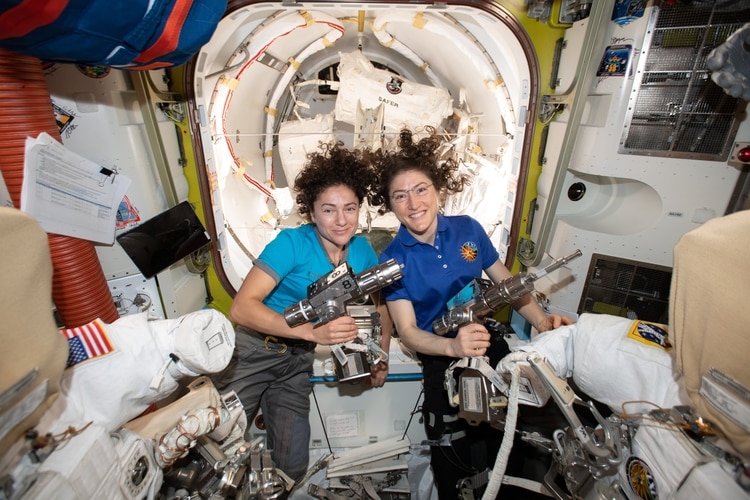 Astronautas Christina Koch, derecha y Jessica Meir posan para una foto en la Estación Espacial Internacional. Serán las primeras mujeres en realizar una caminata espacial exclusivamente femenina (NASA, vía AP)