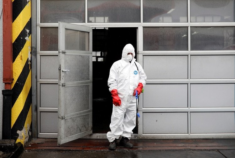 A staff member at city transport company wearing protective clothing arrives to disinfect a bus as new coronavirus disease (COVID-19) cases are reported in Skopje, North Macedonia March 7, 2020.REUTERS/Ognen Teofilovski